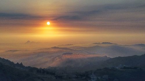 Scenic view of mountains against sky during sunset