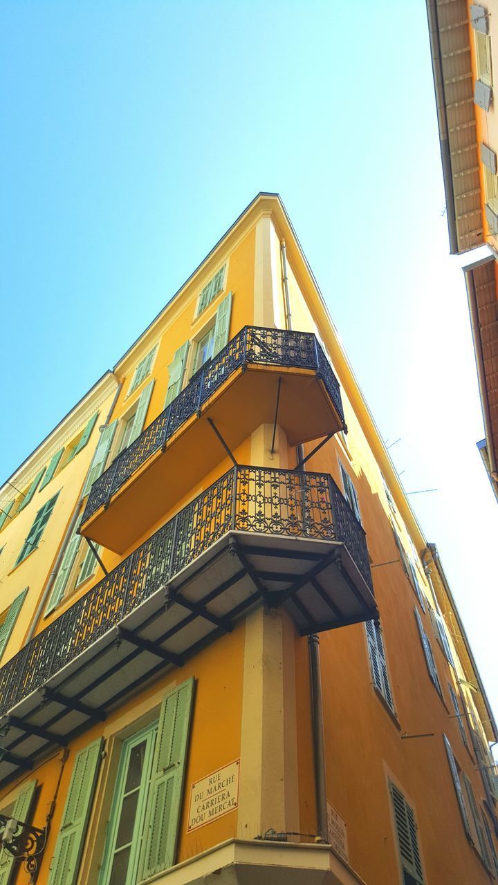 LOW ANGLE VIEW OF YELLOW BUILDING