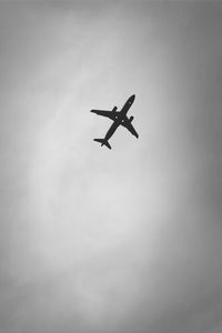 Low angle view of airplane flying in sky