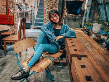 Portrait of smiling young woman sitting outdoors