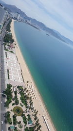 High angle view of beach by sea against sky