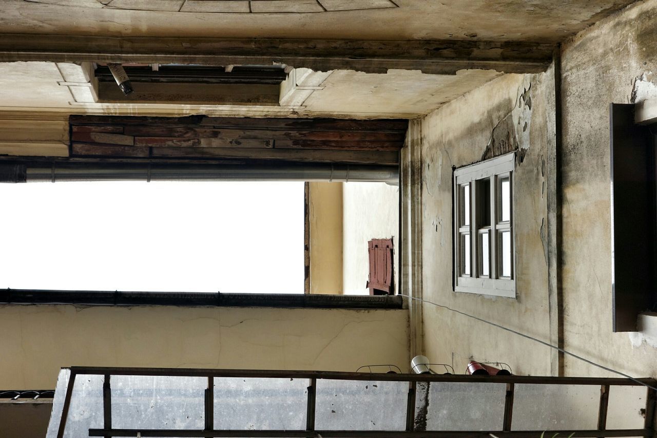 architecture, built structure, building exterior, window, indoors, house, abandoned, building, day, old, sunlight, weathered, low angle view, obsolete, damaged, residential structure, no people, residential building, architectural column, balcony