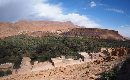 Panoramic view of houses and mountains against sky