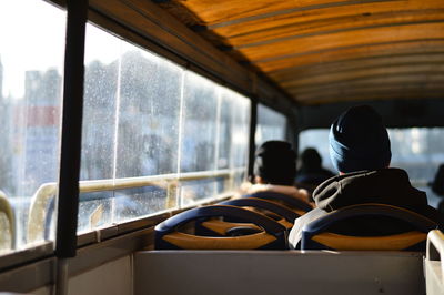 Rear view of passengers sitting in bus