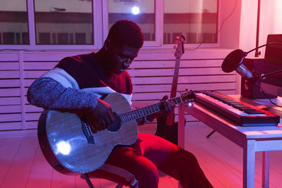 Man playing guitar at music concert