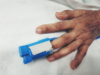 Close-up of hand holding white table