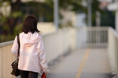 Rear view of woman walking on street