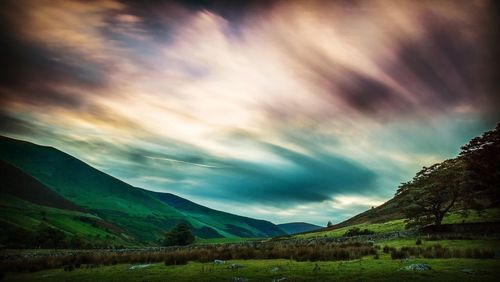 Countryside landscape against cloudy sky