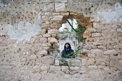 Full length portrait of woman against wall