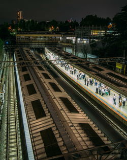 High angle view of railroad tracks against sky at night