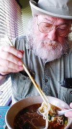 Close-up of man eating food at home