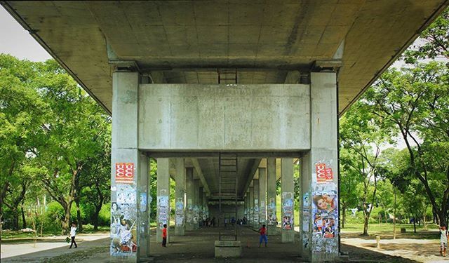 architecture, built structure, tree, transportation, text, graffiti, building exterior, road, street, men, western script, person, day, communication, city, outdoors, architectural column, incidental people, lifestyles