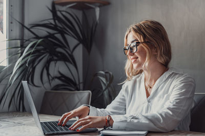 Young woman using laptop at home