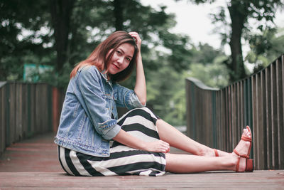 Portrait of a young woman sitting outdoors