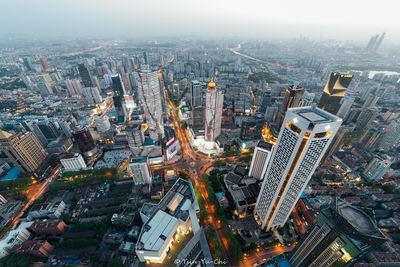 High angle view of modern buildings in city against sky