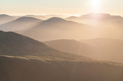 Scenic view of mountains against sky during sunset