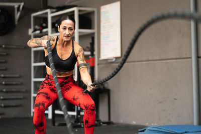 Low section of woman exercising in gym