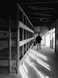 Rear view of man walking in building