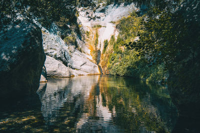 Scenic view of lake by rock formation