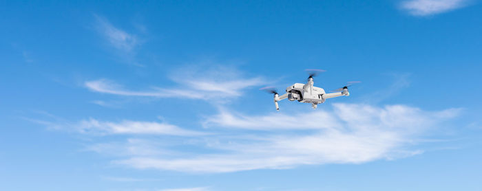 Low angle view of airplane flying against sky