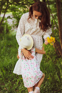 Little girl hugging her mother in the forest