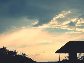 Low angle view of silhouette building against sky during sunset