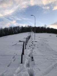 Scenic view of snow covered field against sky