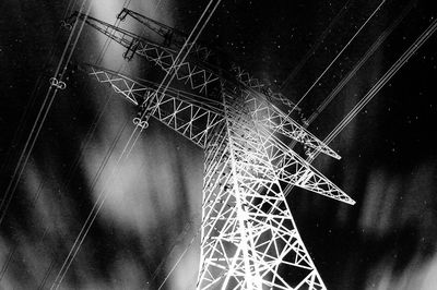 Low angle view of illuminated lights against sky at night