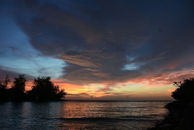 View of sea against cloudy sky during sunset