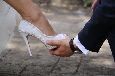 Low section of couple holding hands