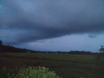 Scenic view of field against cloudy sky