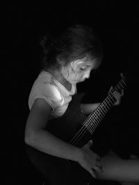 Man playing guitar at home