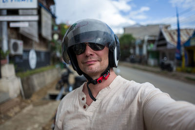 Portrait of mature man wearing helmet on road