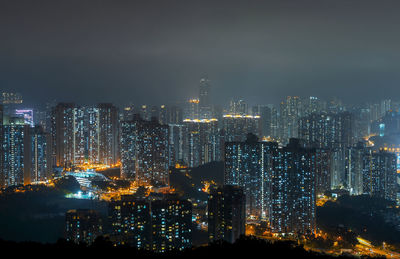 High angle view of illuminated buildings against sky at night