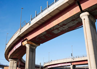 Low angle view of bridge against clear blue sky