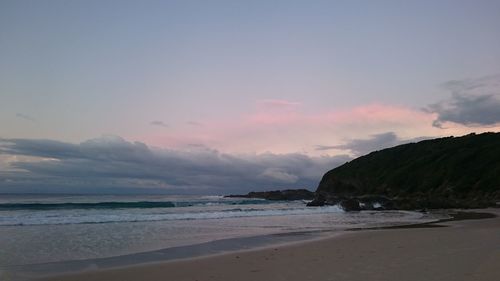 Scenic view of beach against sky during sunset