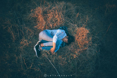 High angle view of woman relaxing on field