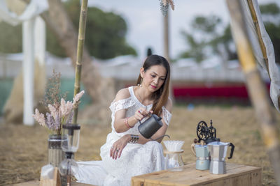 Beautiful woman making drip coffee with hot water poured from the kettle. gives you a cool 