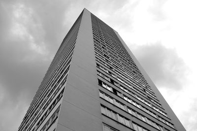 Low angle view of modern building against cloudy sky