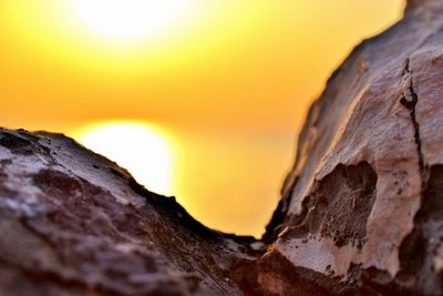 Close-up of rock formation against orange sky