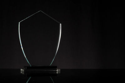 Close-up of shield on table against black background