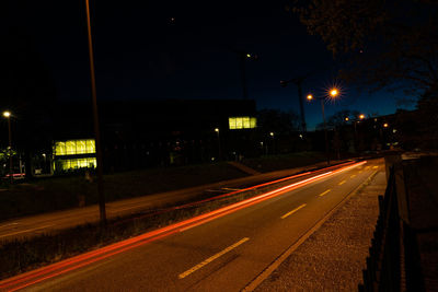 Light trails on road in city at night