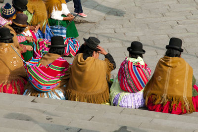 Rear view of people sitting on steps