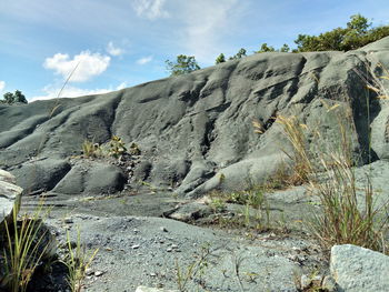 Rock formations on landscape against sky