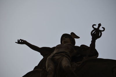 Low angle view of statue against sky