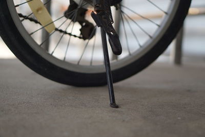 Low section of man with bicycle on metal