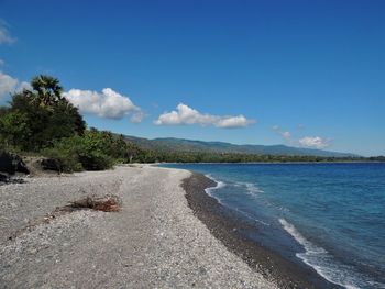 Scenic view of sea against blue sky