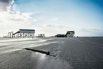 Pier over sea against sky during winter