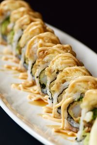 Close-up of shrimp tempura roll with mayo sauce on top 