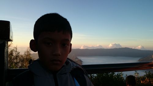 Portrait of boy against sky during sunset